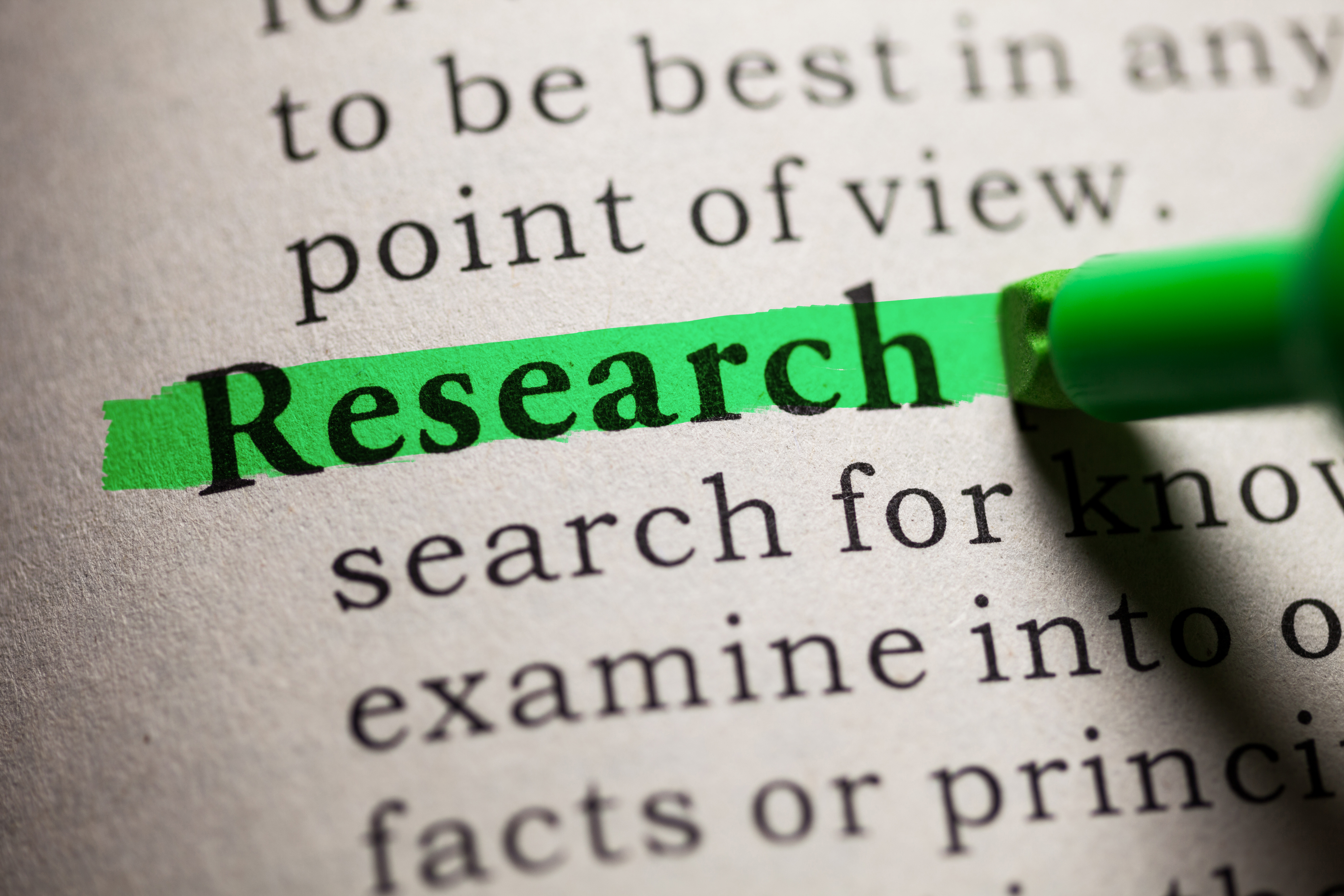 definition of research highlighted in a dictionary