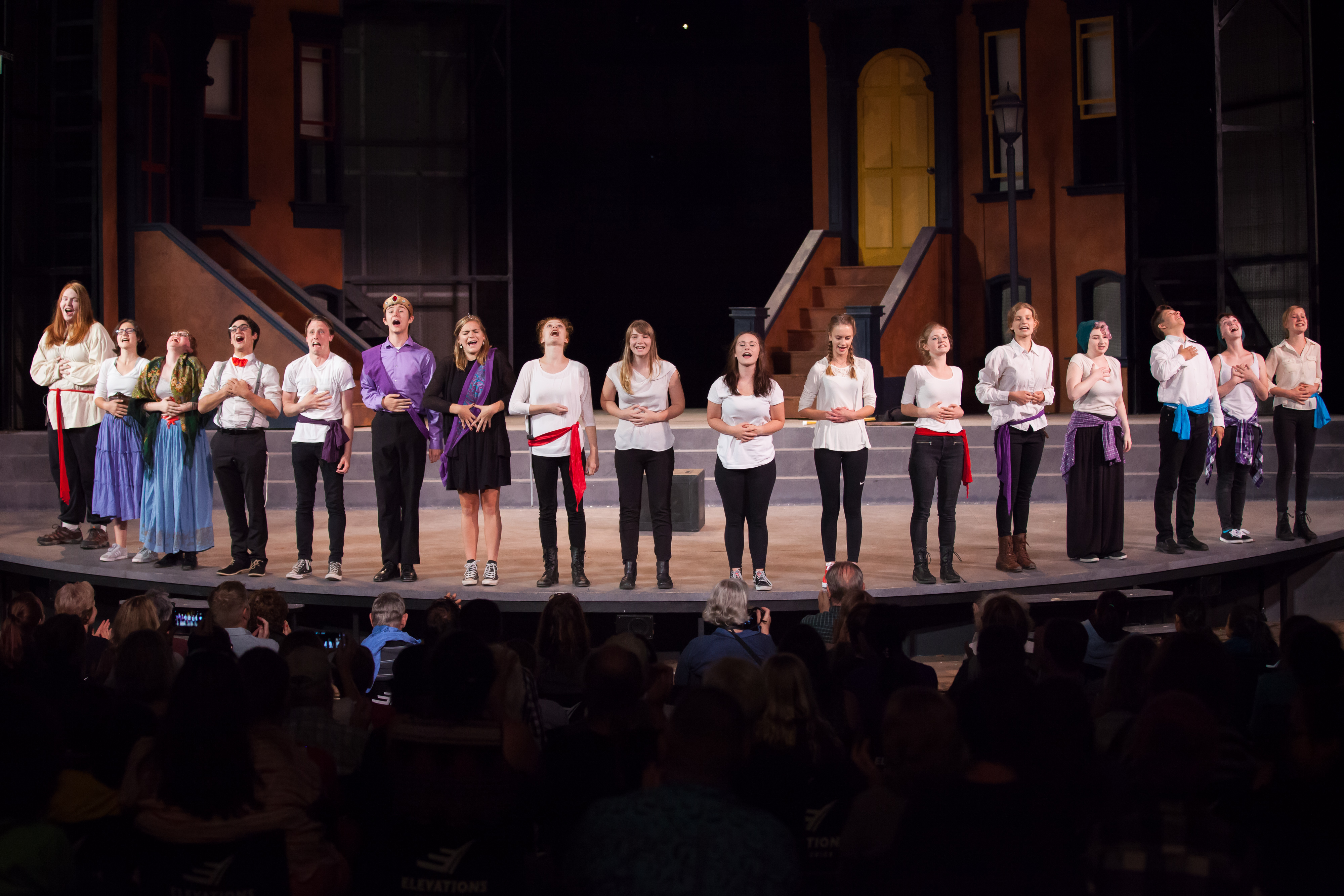 Young students take a bow on stage