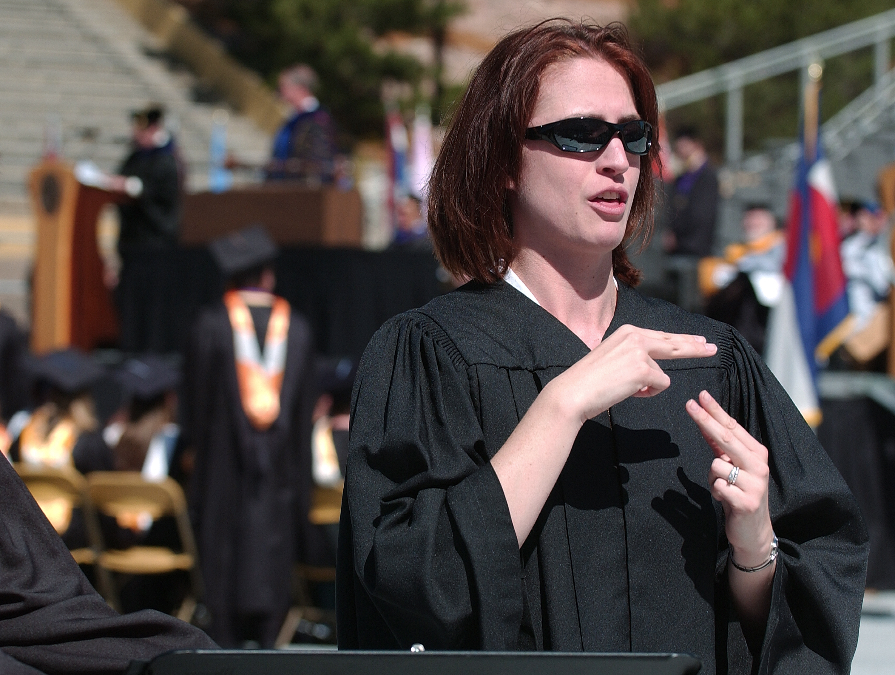 Person speaking sign language at commencement