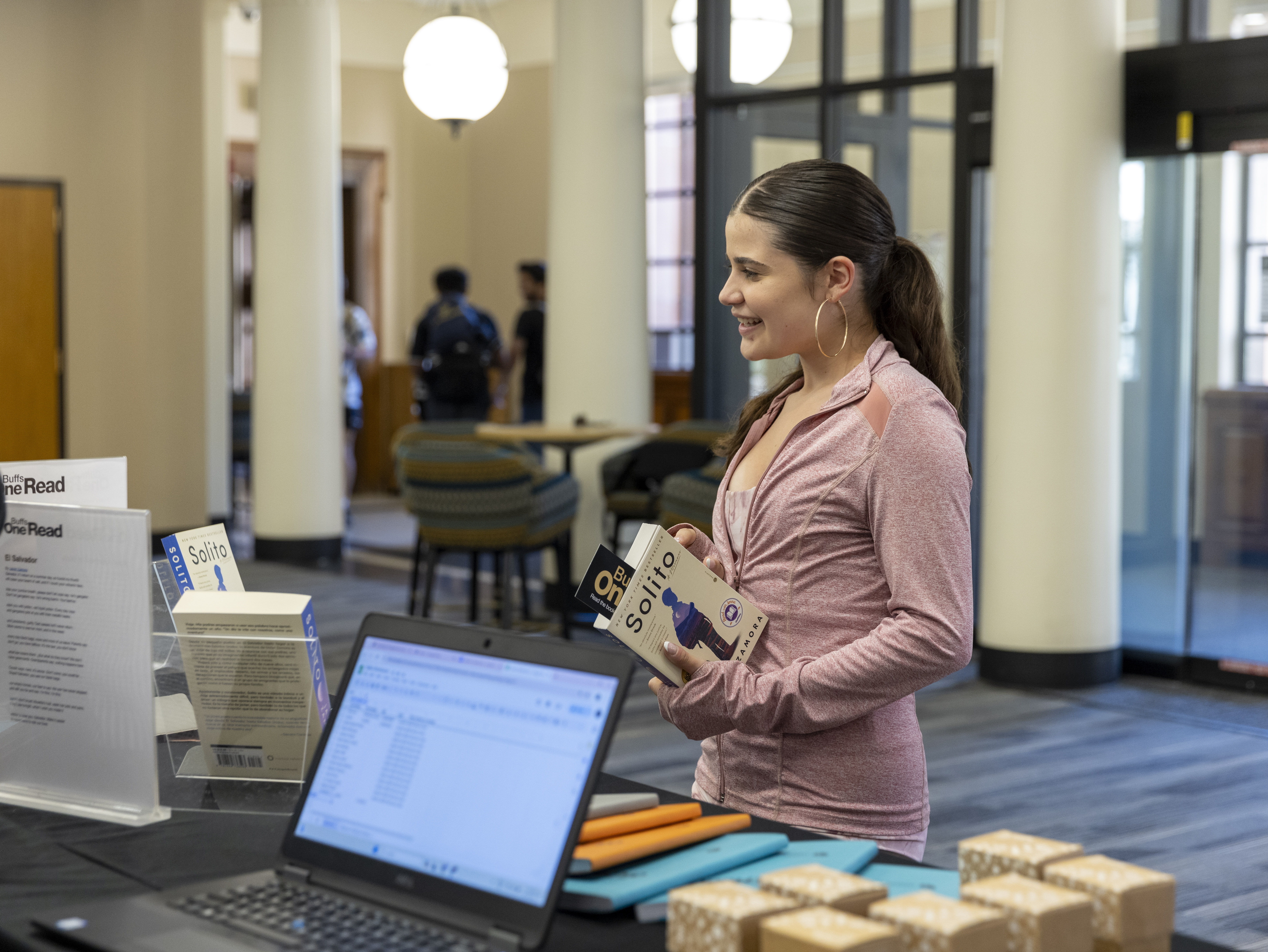 campus community member holding the book 'Solito'