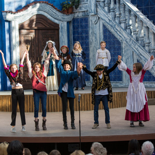 Young students on stage at curtain call
